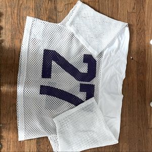 This is a white T with purple markings. Very baggy. Quite thick